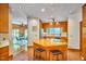 Spacious kitchen with a central island, wood cabinets, and connection to a sunroom at 37 Wedgewood Rd, Chapel Hill, NC 27514