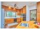 Traditional kitchen with wood cabinetry, stainless steel appliances, and a window overlooking the backyard at 37 Wedgewood Rd, Chapel Hill, NC 27514