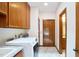 Bright laundry room features wood cabinets, tile flooring, and a utility sink for added convenience at 37 Wedgewood Rd, Chapel Hill, NC 27514