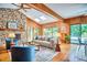 Living room featuring stone fireplace, wood panels, and vaulted ceiling at 37 Wedgewood Rd, Chapel Hill, NC 27514