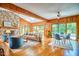 Open living area featuring stone fireplace and a view of the outdoor pool at 37 Wedgewood Rd, Chapel Hill, NC 27514