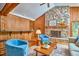Living room with stone fireplace, bar, wood walls, and modern furnishings at 37 Wedgewood Rd, Chapel Hill, NC 27514