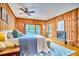 Comfortable main bedroom featuring wood paneling, a fireplace, ceiling fan, and a balcony access at 37 Wedgewood Rd, Chapel Hill, NC 27514