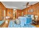 Large main bedroom features wood paneled walls, ceiling fan, and ensuite bathroom for convenience at 37 Wedgewood Rd, Chapel Hill, NC 27514