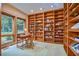 Well-lit home office with custom built-in bookshelves and a large window at 37 Wedgewood Rd, Chapel Hill, NC 27514