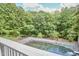 Backyard view featuring a covered swimming pool and lush greenery from the balcony at 37 Wedgewood Rd, Chapel Hill, NC 27514