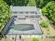 Aerial view of home featuring a large in-ground pool, patio, balconies and scenic wooded surroundings at 37 Wedgewood Rd, Chapel Hill, NC 27514