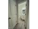 Well-lit powder room featuring wood-look floors, a vanity with storage, and a stylish oval mirror at 391 Curling Creek Dr Dr, Clayton, NC 27527