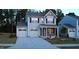 Charming two-story home boasts a two-car garage, covered porch, and well-maintained landscaping at 391 Curling Creek Dr Dr, Clayton, NC 27527