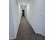 Well-lit hallway with carpet and white walls leading to bedrooms, bathrooms, and other living areas at 391 Curling Creek Dr Dr, Clayton, NC 27527