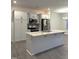 Modern kitchen with stainless appliances, white cabinetry, and a large center island with quartz countertop at 391 Curling Creek Dr Dr, Clayton, NC 27527
