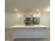 Modern kitchen with stainless appliances, white cabinetry, and a large center island with quartz countertop at 391 Curling Creek Dr Dr, Clayton, NC 27527