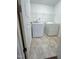Functional laundry room featuring a washer, dryer, and wire shelving for storage at 391 Curling Creek Dr Dr, Clayton, NC 27527
