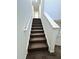 Carpeted staircase leading upstairs with white walls and a white banister at 391 Curling Creek Dr Dr, Clayton, NC 27527