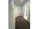Spacious walk-in closet with wire shelves, brown carpeting and an attached bathroom with glass shower at 391 Curling Creek Dr Dr, Clayton, NC 27527