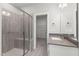 Bathroom featuring a tiled shower, a vanity with quartz countertop, and a walk-in closet at 40 W Victoria Ridge Dr # 18, Selma, NC 27576