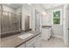 Elegant bathroom featuring dual sinks, stone countertops, a tiled shower, and a window for natural light at 40 W Victoria Ridge Dr # 18, Selma, NC 27576