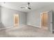 Bedroom features natural light, a ceiling fan, gray walls, and access to two other rooms at 40 W Victoria Ridge Dr # 18, Selma, NC 27576