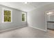 This bedroom features neutral carpet, gray walls, base molding, and two bright windows at 40 W Victoria Ridge Dr # 18, Selma, NC 27576