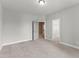 Spacious bedroom with neutral carpet, gray walls, and access to the closet and other room at 40 W Victoria Ridge Dr # 18, Selma, NC 27576
