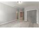 This bedroom features neutral carpet, gray walls, base molding, and closet doors at 40 W Victoria Ridge Dr # 18, Selma, NC 27576