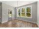 Sun-filled dining area with hardwood floors, modern lighting, and views of the landscaped backyard at 40 W Victoria Ridge Dr # 18, Selma, NC 27576