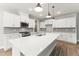 Modern kitchen boasts a large island, white cabinetry, and stainless steel appliances at 40 W Victoria Ridge Dr # 18, Selma, NC 27576
