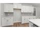 Bright kitchen showcases custom white cabinetry and stainless appliances with decorative backsplash at 40 W Victoria Ridge Dr # 18, Selma, NC 27576