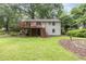 Exterior view of the home features a deck and manicured lawn, perfect for outdoor entertaining and relaxation at 421 Ridgefield Rd Rd, Chapel Hill, NC 27517