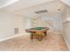Finished basement with a pool table and stairs to the upper floor at 421 Ridgefield Rd Rd, Chapel Hill, NC 27517