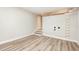 Spacious basement with painted brick accent wall, wood stairs, and woodgrain flooring at 421 Ridgefield Rd Rd, Chapel Hill, NC 27517