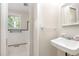 Bright bathroom features white tile and fixtures, with a window for natural light at 421 Ridgefield Rd Rd, Chapel Hill, NC 27517