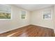 Bright bedroom with hardwood floors and three windows offering ample natural light at 421 Ridgefield Rd Rd, Chapel Hill, NC 27517