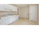 Kitchen area with white cabinets, a sink, and a dishwasher next to a pantry at 421 Ridgefield Rd Rd, Chapel Hill, NC 27517