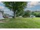 A sprawling backyard with mature trees, pool, greenhouse, and outbuildings offers endless possibilities for outdoor living at 444 Barnette Rd, Louisburg, NC 27549