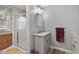 Neutral-toned bathroom featuring a walk-in shower and modern vanity with grey accents at 444 Barnette Rd, Louisburg, NC 27549