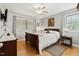 Bedroom featuring hardwood floors, white linens, a fan, and wooden furniture at 444 Barnette Rd, Louisburg, NC 27549