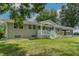 Charming brick ranch with a covered porch, white picket fence, and manicured lawn at 444 Barnette Rd, Louisburg, NC 27549