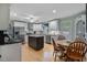 Bright kitchen featuring white cabinets, a kitchen island, stainless steel appliances, and a round dining table at 444 Barnette Rd, Louisburg, NC 27549