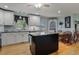 Well-lit kitchen with an island, dining area and modern appliances at 444 Barnette Rd, Louisburg, NC 27549
