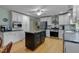 Bright, modern kitchen with a large island, stainless steel appliances, and white cabinetry at 444 Barnette Rd, Louisburg, NC 27549