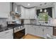 Modern kitchen featuring stainless steel appliances, granite countertops, and a stylish design at 444 Barnette Rd, Louisburg, NC 27549