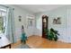 Cozy living room featuring warm paint color, a guitar, plants and vintage grandfather clock at 444 Barnette Rd, Louisburg, NC 27549