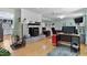 Open-concept living room with a fireplace, seating area, and light hardwood floors at 444 Barnette Rd, Louisburg, NC 27549