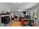 Bright living room featuring a fireplace, hardwood floors and natural light from the large window at 444 Barnette Rd, Louisburg, NC 27549