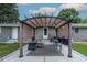 Cozy outdoor patio area featuring a charming pergola, seating, and a stylish area rug, perfect for relaxing at 444 Barnette Rd, Louisburg, NC 27549