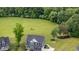 Aerial view of a two-story home with well-maintained lawn, trees, and driveway at 45 Leighann S Ct, Timberlake, NC 27583
