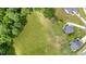An aerial view of a home on a lot with a green lawn, surrounded by trees at 45 Leighann S Ct, Timberlake, NC 27583