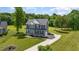 Aerial view of a gray two-story house with a long driveway and large green lawn at 45 Leighann S Ct, Timberlake, NC 27583