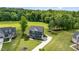 An aerial view of a beautiful home with a large green lawn and surrounding trees at 45 Leighann S Ct, Timberlake, NC 27583
